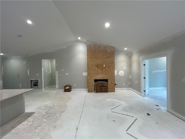 unfurnished living room featuring a fireplace and lofted ceiling