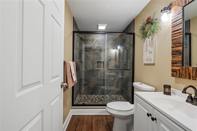 bathroom featuring toilet, walk in shower, vanity, and wood-type flooring