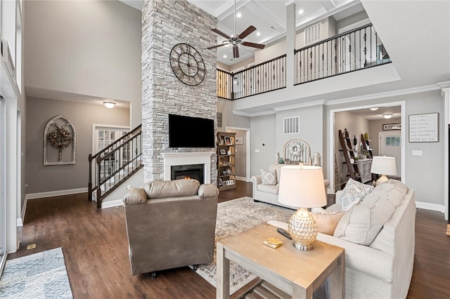 living room with a high ceiling, coffered ceiling, dark wood-type flooring, and beam ceiling