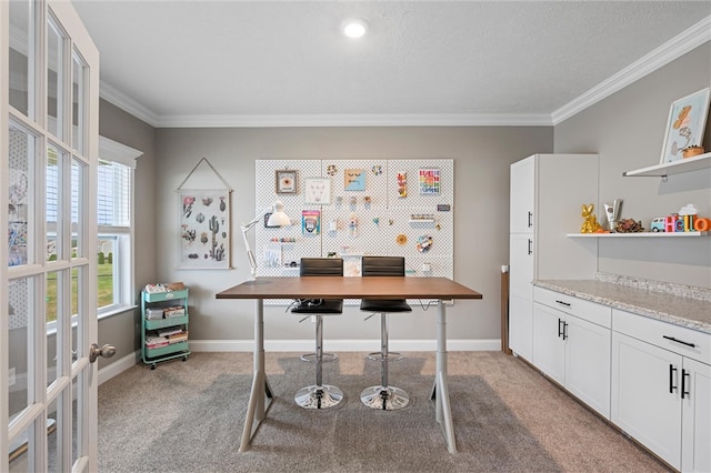 carpeted office with crown molding and a textured ceiling