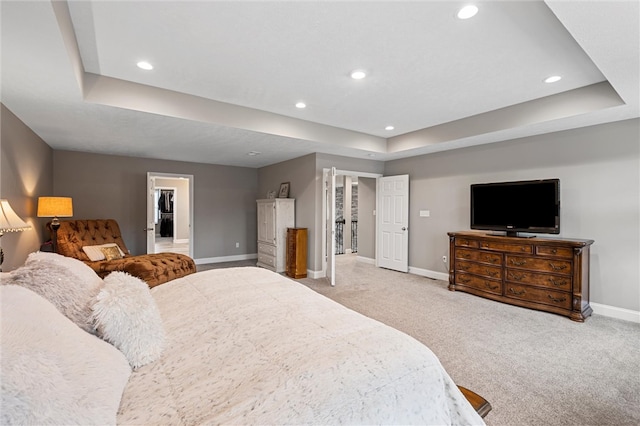 bedroom featuring a raised ceiling and carpet