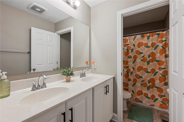 bathroom with tile patterned flooring, a shower with shower curtain, vanity, and toilet