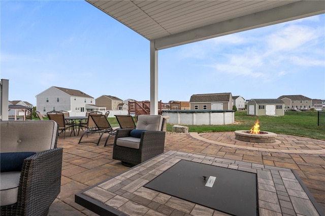 view of patio featuring a fire pit and a pool