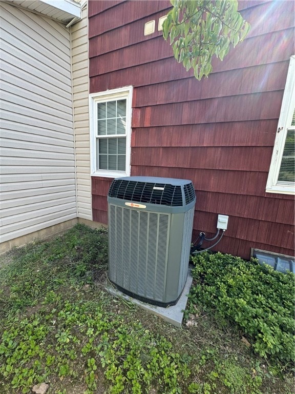 details featuring cooling unit and wood walls