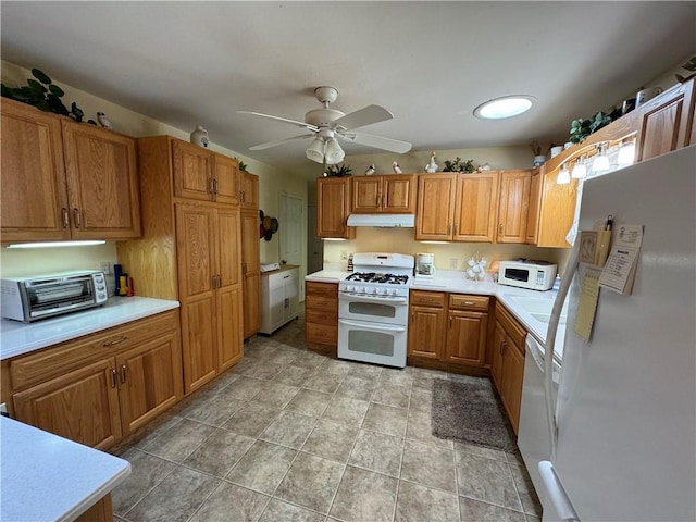 kitchen with a toaster, white appliances, light countertops, under cabinet range hood, and ceiling fan