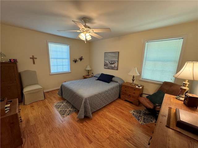 bedroom with light hardwood / wood-style floors and ceiling fan