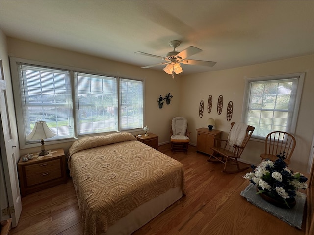 bedroom with ceiling fan and hardwood / wood-style flooring