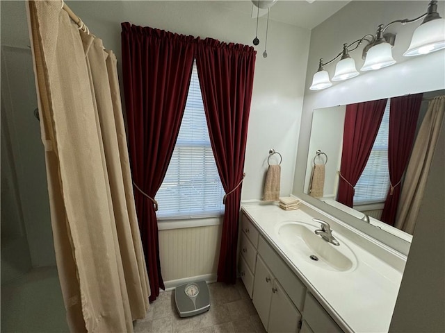 bathroom featuring baseboards and vanity