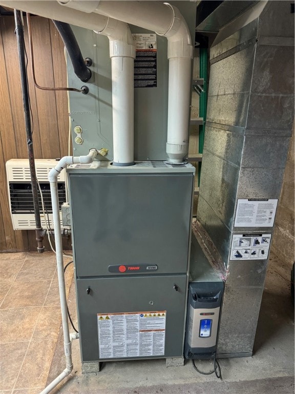 utility room featuring heating unit