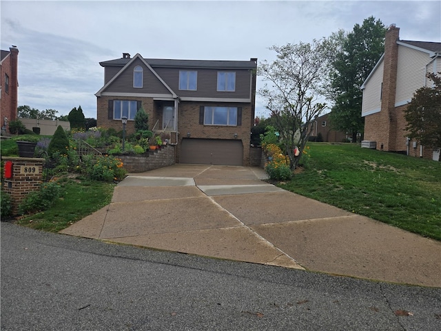 view of front of house featuring a front lawn and a garage