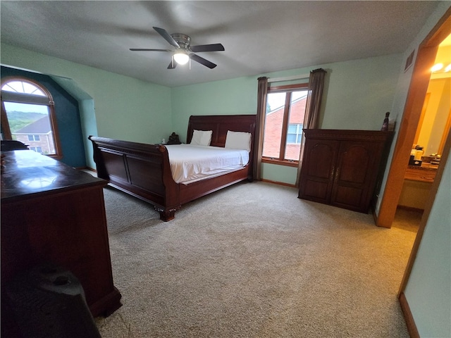 bedroom with ceiling fan and light carpet