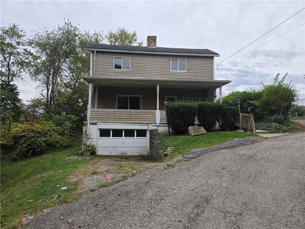 view of front of home with a porch and a garage