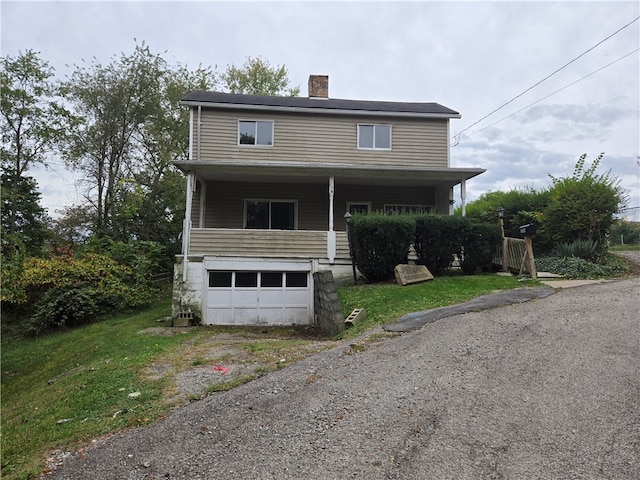 view of front of home with a porch and a garage