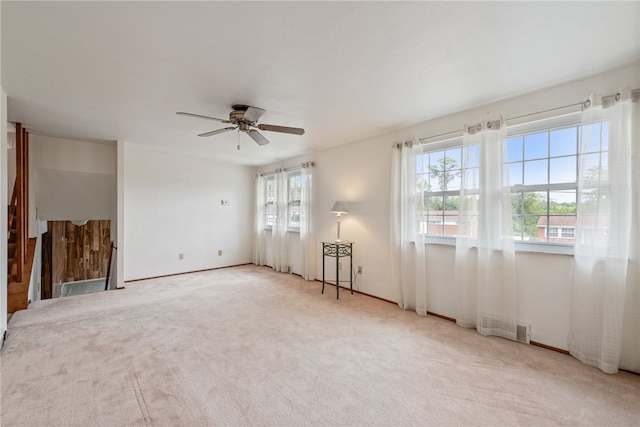 carpeted empty room featuring ceiling fan