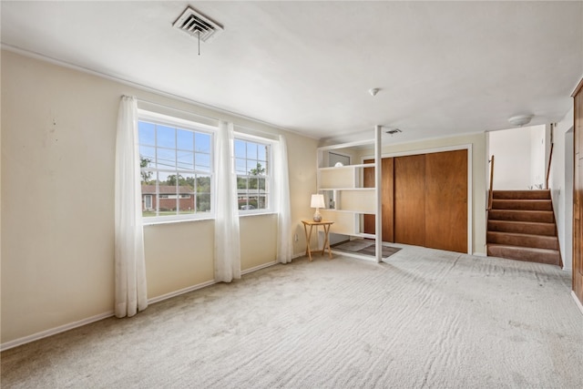 unfurnished living room featuring carpet floors