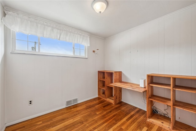 interior space with wood-type flooring and wooden walls