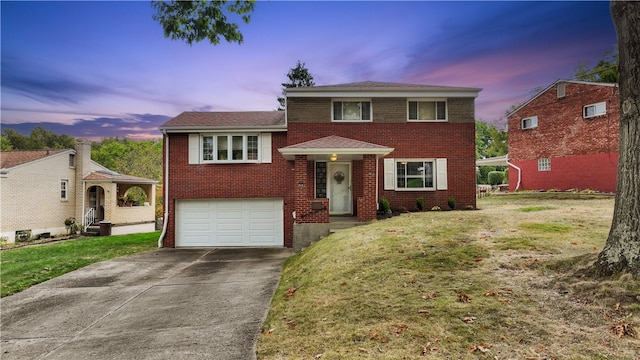 view of front of house with a yard and a garage