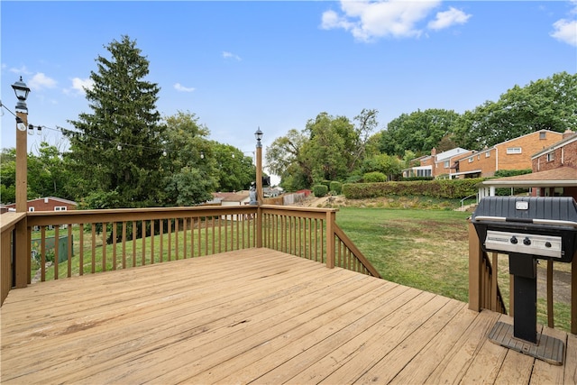 wooden deck featuring a lawn