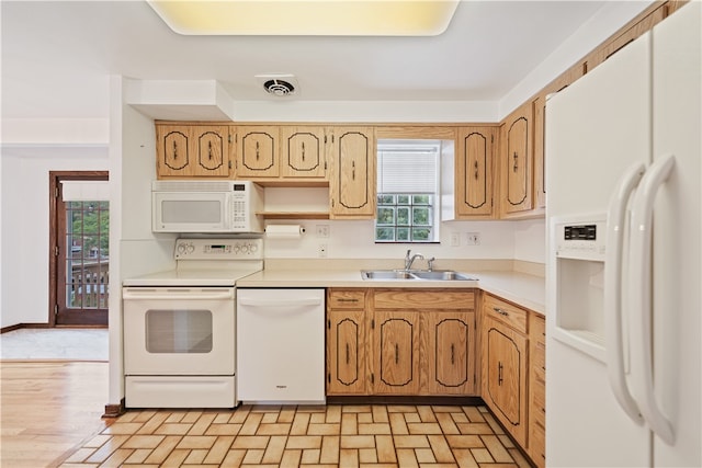 kitchen with light hardwood / wood-style flooring, white appliances, and sink