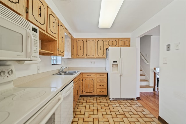 kitchen featuring light hardwood / wood-style floors, white appliances, and sink