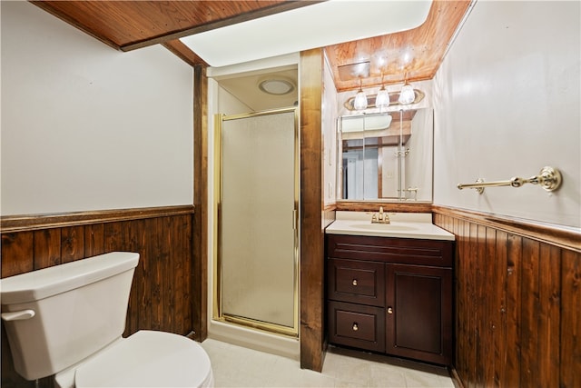 bathroom featuring wood walls, vanity, a shower with shower door, and toilet