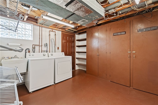 laundry room featuring washing machine and dryer and sink