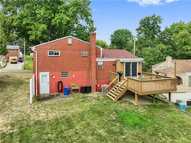 back of house with a wooden deck, a yard, and central AC