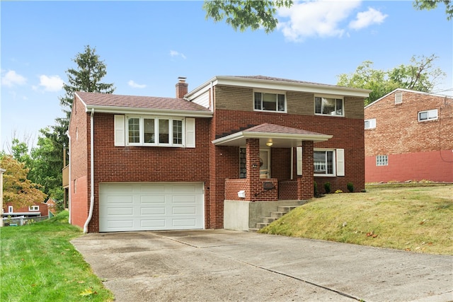 view of front of home featuring a front yard and a garage