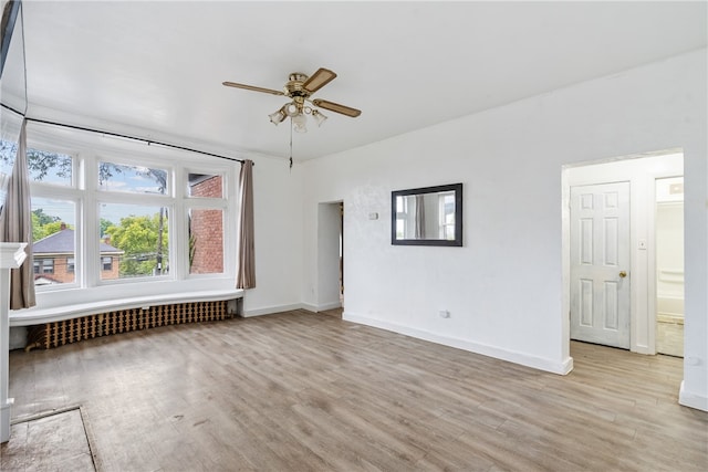 unfurnished living room with light hardwood / wood-style floors and ceiling fan