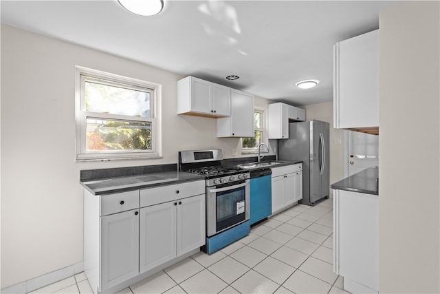 kitchen with light tile patterned flooring, white cabinetry, sink, and stainless steel appliances