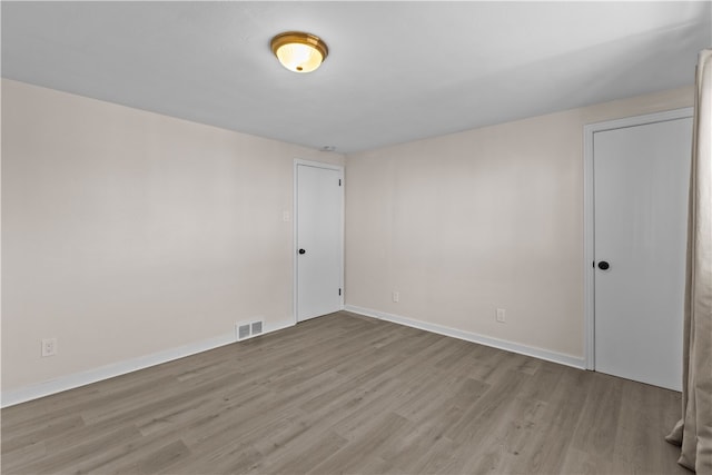 spare room with light wood-type flooring