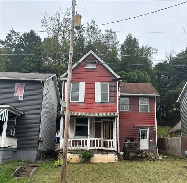 back of property featuring a lawn and a porch