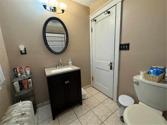 bathroom with tile patterned flooring, a notable chandelier, a textured ceiling, toilet, and vanity