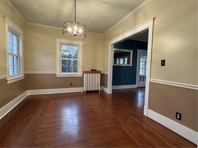 unfurnished dining area featuring a notable chandelier, a healthy amount of sunlight, a textured ceiling, and radiator