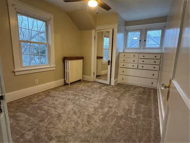 additional living space with ceiling fan, carpet floors, radiator, and vaulted ceiling