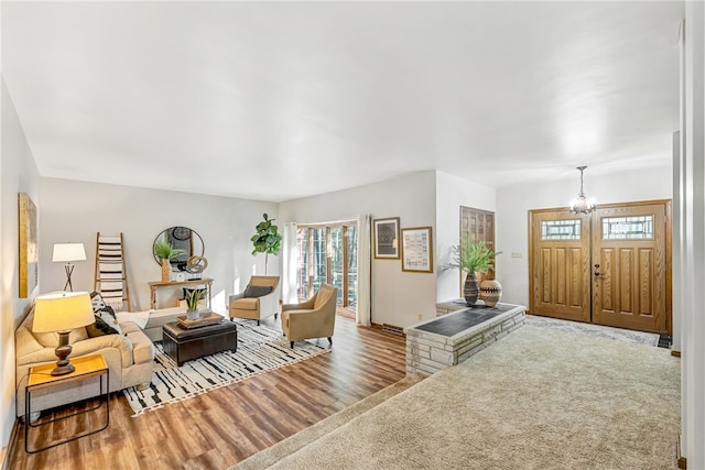 living room featuring wood-type flooring and an inviting chandelier