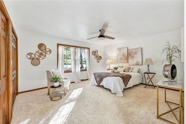 carpeted bedroom featuring ceiling fan and a closet