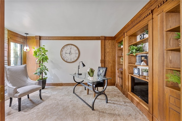 carpeted home office featuring built in shelves and wooden walls