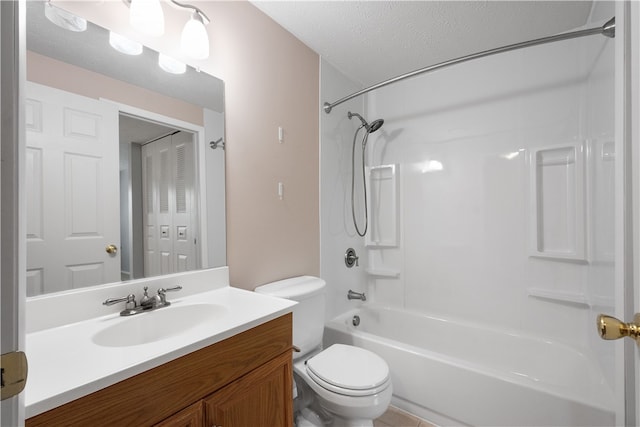 full bathroom with vanity, toilet, a textured ceiling, washtub / shower combination, and tile patterned flooring