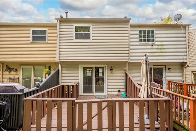 back of property featuring a wooden deck