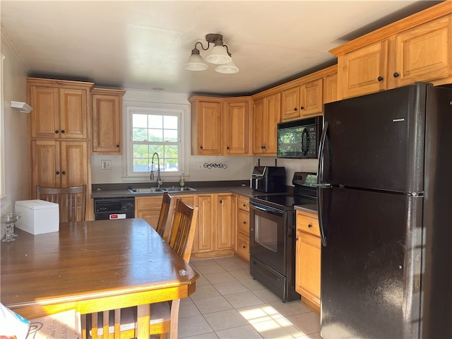 kitchen with black appliances, sink, and light tile patterned floors