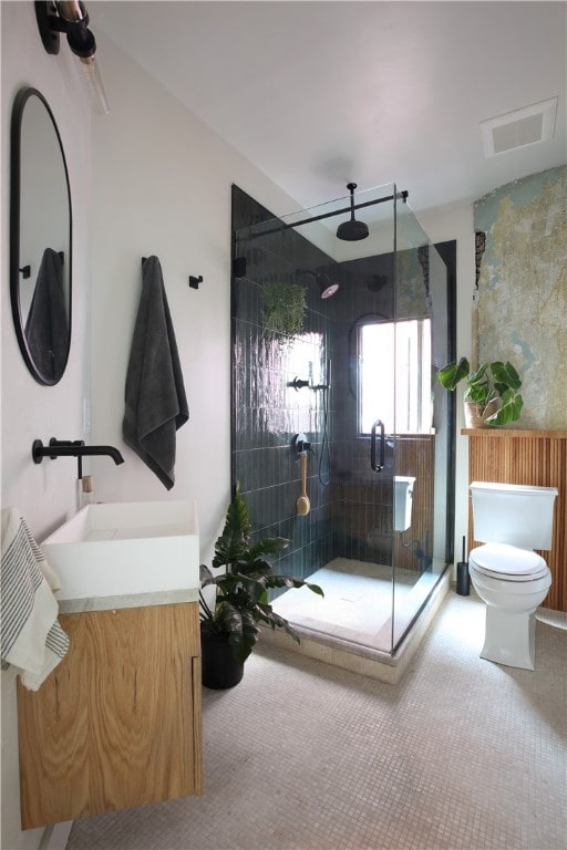 bathroom with vanity, toilet, and an enclosed shower