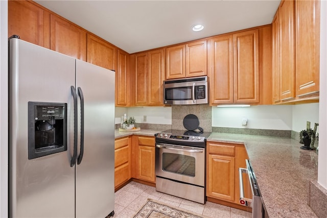 kitchen featuring light tile patterned floors and stainless steel appliances