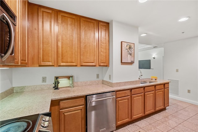 kitchen with light stone counters, sink, stainless steel appliances, and light tile patterned floors