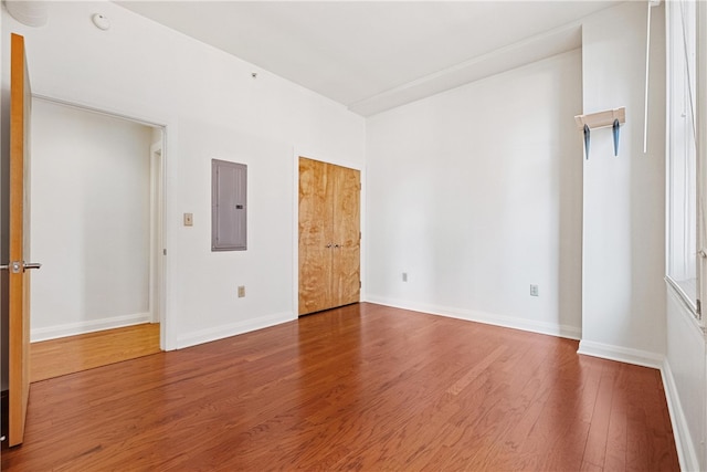 unfurnished room featuring hardwood / wood-style floors and electric panel