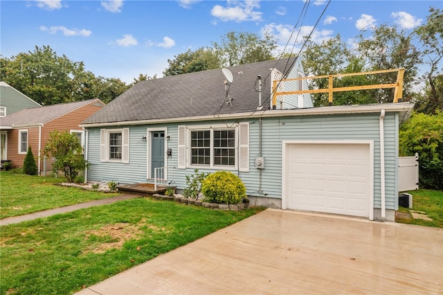 view of front of home with a front yard and a garage