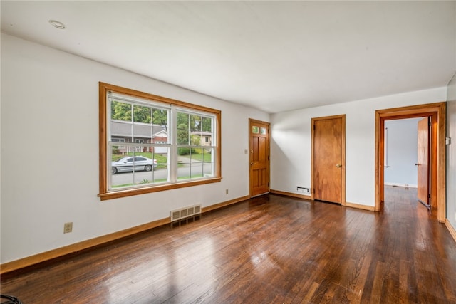 empty room with dark hardwood / wood-style floors