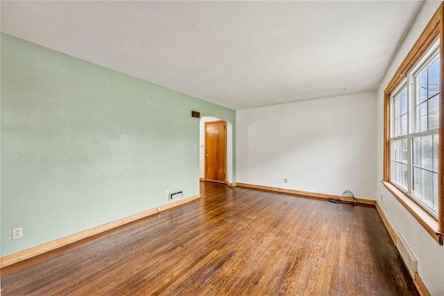 unfurnished room featuring hardwood / wood-style flooring