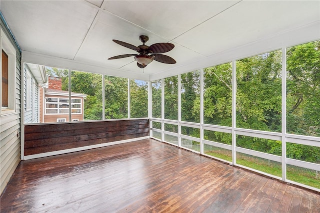 unfurnished sunroom featuring ceiling fan and a wealth of natural light