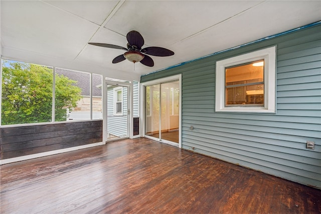 unfurnished sunroom featuring ceiling fan